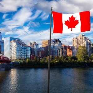 National Canadian Flag Composite. Peace Bridge across Bow River during a vibrant summer sunrise. Urban Downtown City Skyline. Taken in Calgary, Alberta, Canada.